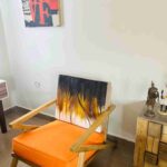 Handcrafted Abstract Backrest Accent Chair with Bold Orange Cushion – Woodsworthinterior